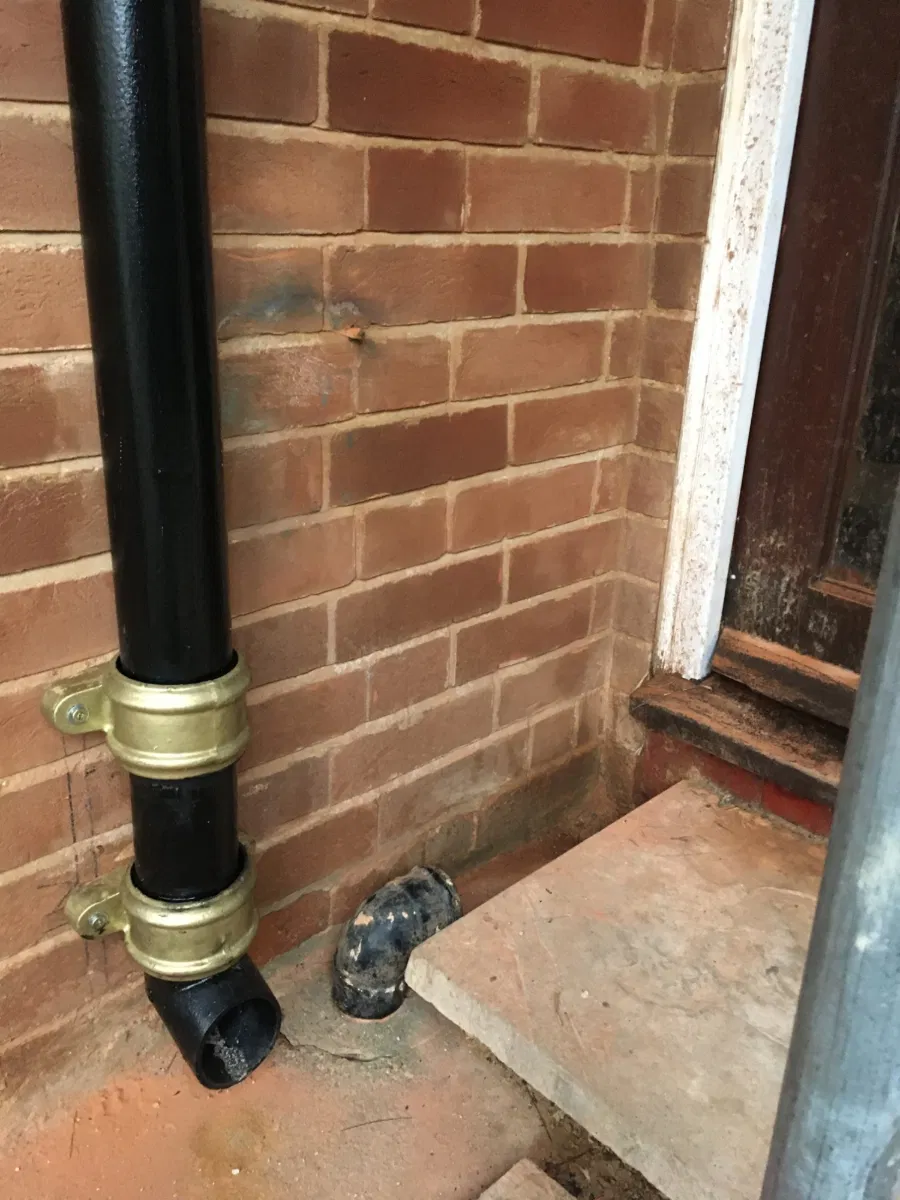 Black cast iron downpipes with eared shoe